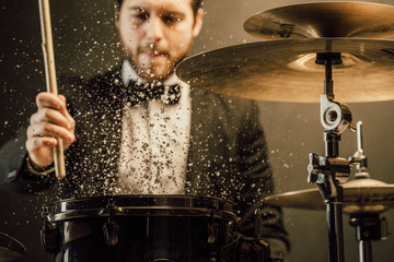 drummer plays in the hall poses