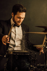 drummer plays in the hall poses