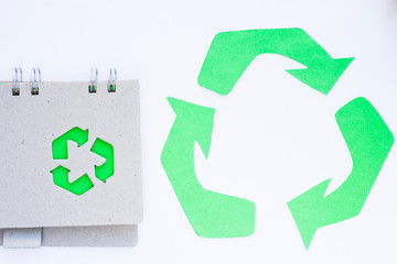 Environmental protection, ecology and recycling concept, recycle sign, notepad and garbage on white background