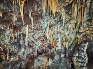 View of stalactites and stalagmites in an underground cavern - Postojna cave in Slovenia