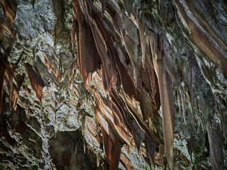 View of stalactites and stalagmites in an underground cavern - Postojna cave in Slovenia