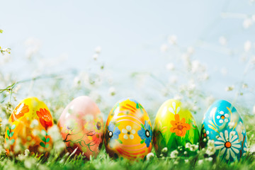 Decorative eggs on green grass.