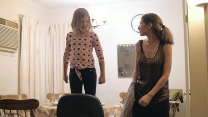 Girls of different ages dancing together at family reunion. Slow motion.