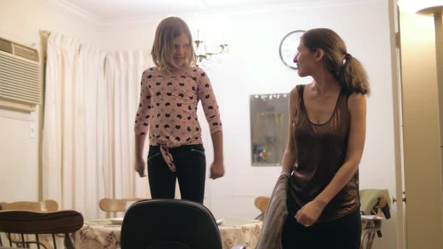 Girls of different ages dancing together at family reunion. Slow motion.