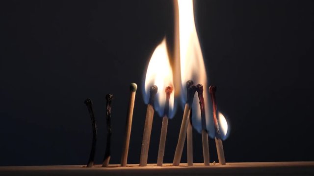 matches sulfur burn with a red flame on a dark background