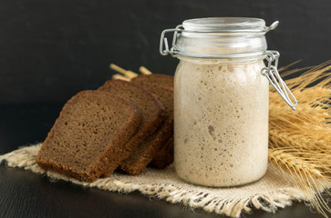 Active rye sourdough in a glass jar for homemade bread.
