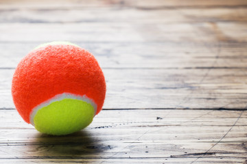 Tennis Ball on Wood Background, Sport Concept and Idea, Rustic Style. © Elenglush