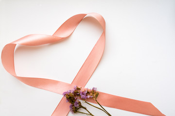 Pink ribbon heart with flowers. Flat lay, top view. Valentines and 8 March Mother Womens Day concept
