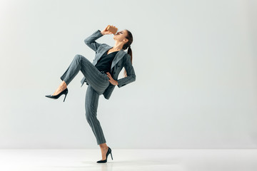 Happy business woman dancing and smiling in motion isolated over white studio background. Human emotions concept. The businesswoman, office, success, professional, , happiness, expression concepts