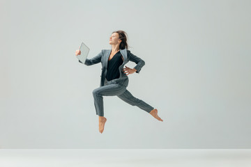 Happy business woman dancing and smiling in motion isolated over white studio background. Human emotions concept. The businesswoman, office, success, professional, , happiness, expression concepts