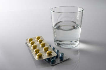 Pills Blister along with a water glass, conceptual image