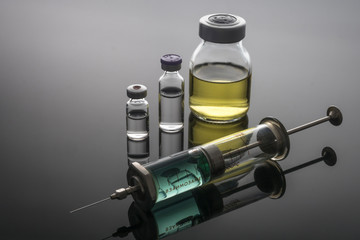 Vintage syringe with vials, conceptual image