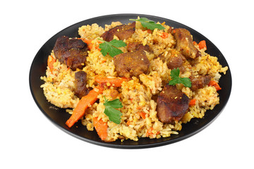 pilaf with meat on black plate isolated on white background