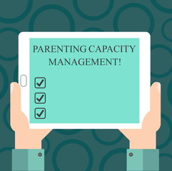 Writing note showing Parenting Capacity Management. Business photo showcasing parents ability to protect children from risk Hu analysis Hand Holding Tablet Smartphone Display Unit photo