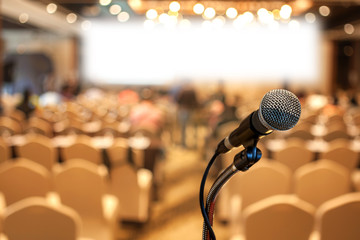 Selective focus Microphone over the blurred of  business forum meeting or seminar room background.