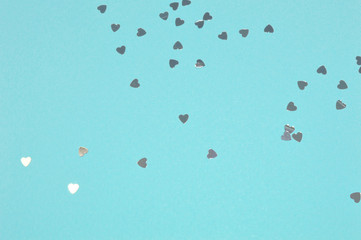 Silver glitter hearts on blue background in vintage colors