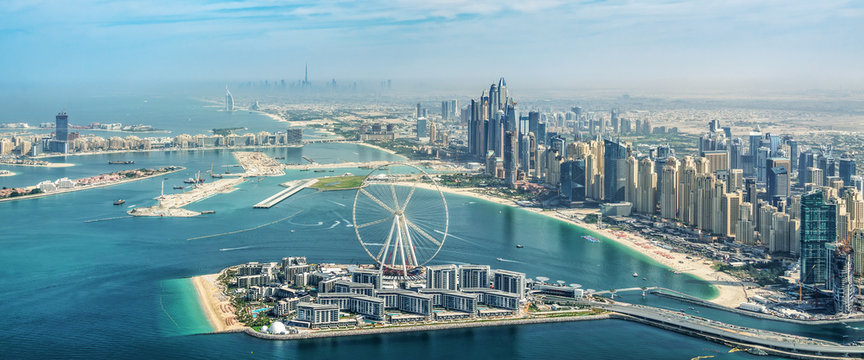 Panoramic aerial view of Dubai Marina skyline with Dubai Eye ferris wheel, United Arab Emirates