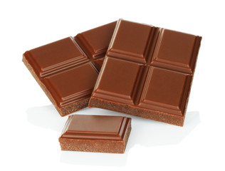 Milk chocolate pieces isolated on white background