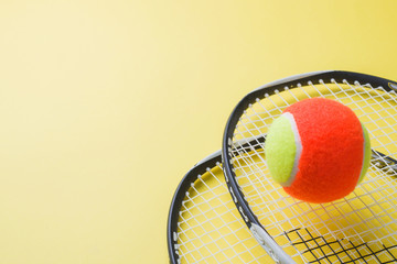 Tennis Ball and rackets on yellow Background, Sport Concept and Idea, © Elenglush