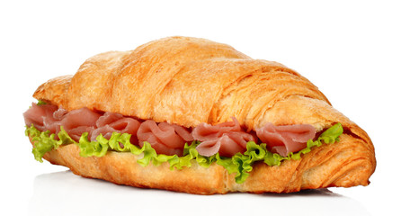 Big croissant with green salad and pork meat