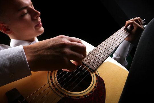 Young men playing the guitar