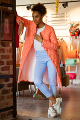 African model woman in orange spring jacket and blue pants