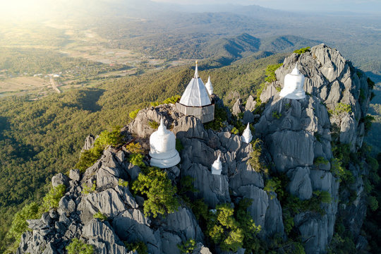 Spectacular aerial view of floating pagodas on the mountain cliff at Wat Chaloem Phra Kiat in Chae Hom District, Lampang province, Thailand.