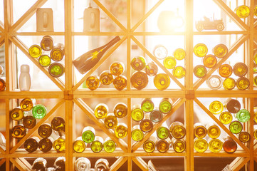 Wine cabinet with bottles and glasses. Daylight
