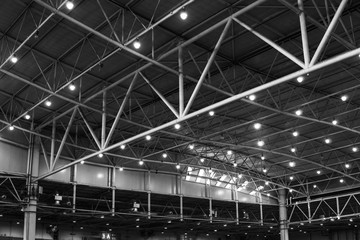 Interior of warehouse. large metal structures, ceiling. roof. concept production and installation of equipment for rooms, lighting, ventilation and windows for hangars, black and white