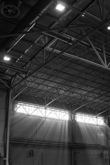 Interior of warehouse. large metal structures, ceiling. roof. concept production and installation of equipment for rooms, lighting, ventilation and windows for hangars, vertical photo, black and white