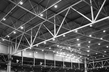 Interior of warehouse. large metal structures, ceiling. roof. concept production and installation of equipment for rooms, lighting, ventilation and windows for hangars, black and white