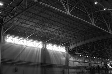 Interior of warehouse. large metal structures, ceiling. roof. concept production and installation of equipment for rooms, lighting, ventilation and windows for hangars, black and white