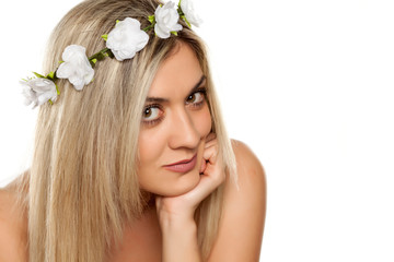 Obraz na płótnie Canvas beautiful young woman with wreath of flowers on her head on white background