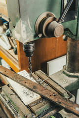 profesional drilling  metal on vertical bench. vintage filter