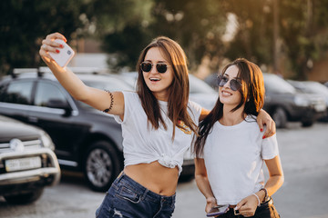 Two young women taking a selfie and have fun