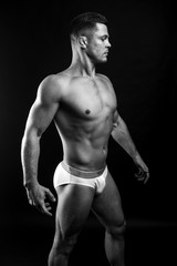 Fototapeta premium strong athletic man on black background