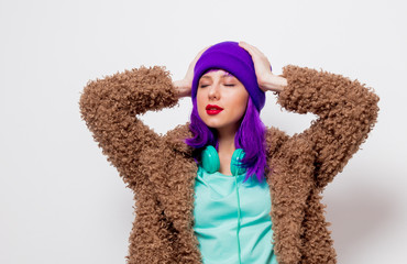 Beautiful young girl with purple hair in jacket on white background.