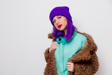 Beautiful young girl with purple hair in jacket on white background.