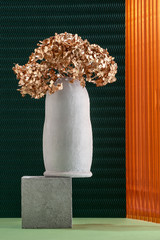 Art installation using elements of concrete, dried flowers and non-traditional textures.