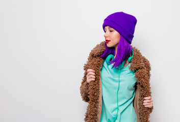 Beautiful young girl with purple hair in jacket on white background.