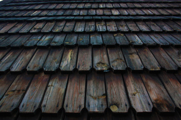 The roof is covered with wooden slate resembling the heads of snakes