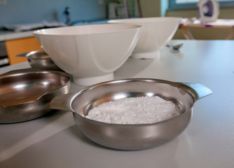 There is white flour in the plate. Children are having a cooking class and will bake something.