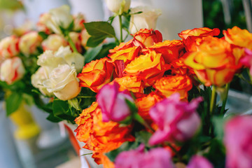Bouquet of roses in a vase in a shop window. Concept of Valentine's day and international Women's day.
