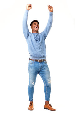 Full body cheerful young black man with arms raised against isolated white background