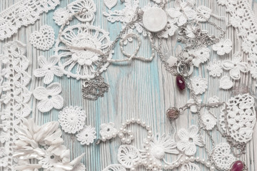 An overhead photo of cotton creative Irish crochet lace white flowers and pearls. Handmade knitted Easter, Christmas, Valentine day backdrop for wedding, birthday, celebration. Place for text.