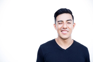 Handsome latin hispanic man is blinking with one eye.