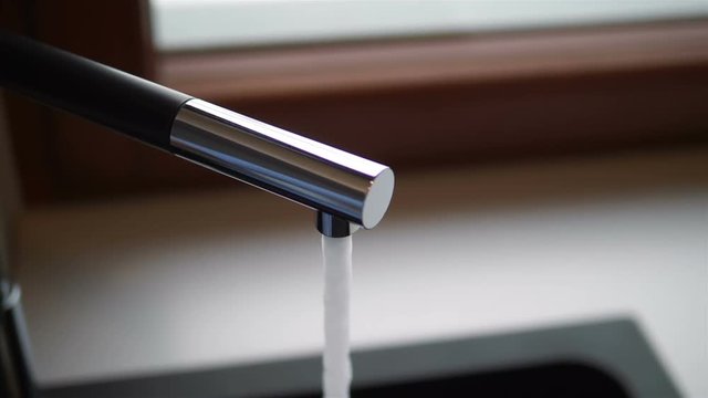 Water dripping from the tap in 4k slow motion 60fps