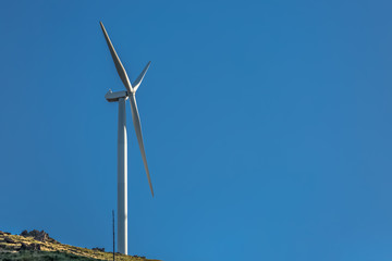 View of a wind turbine on top of mountains