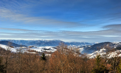 Nice mountains view in snowy sunny day under blue sky with sun light at winter time