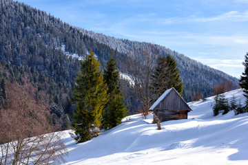 Beautiful winter mountain scenery with traditional mountain hut